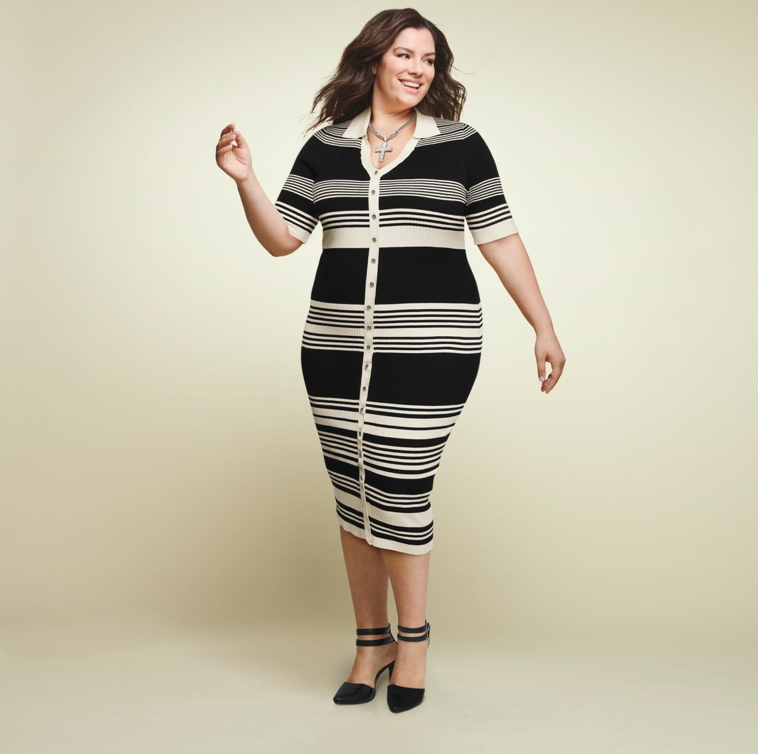 plus size model wearing a stripped white and black knit dress