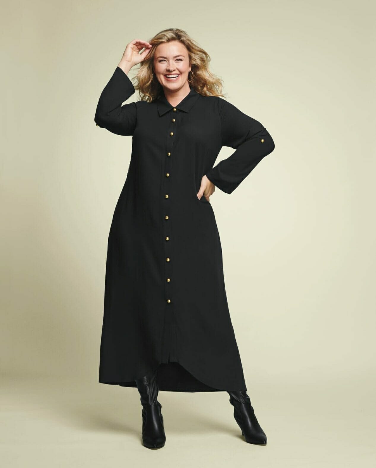 plus size model wearing black long sleeve dress with boots