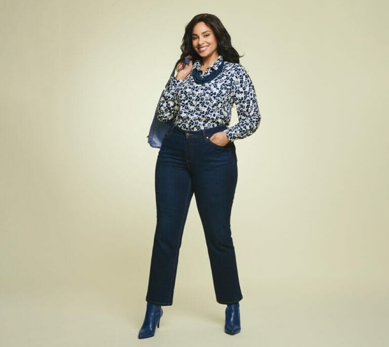 Plus size model wearing floral long sleeve with jeans.