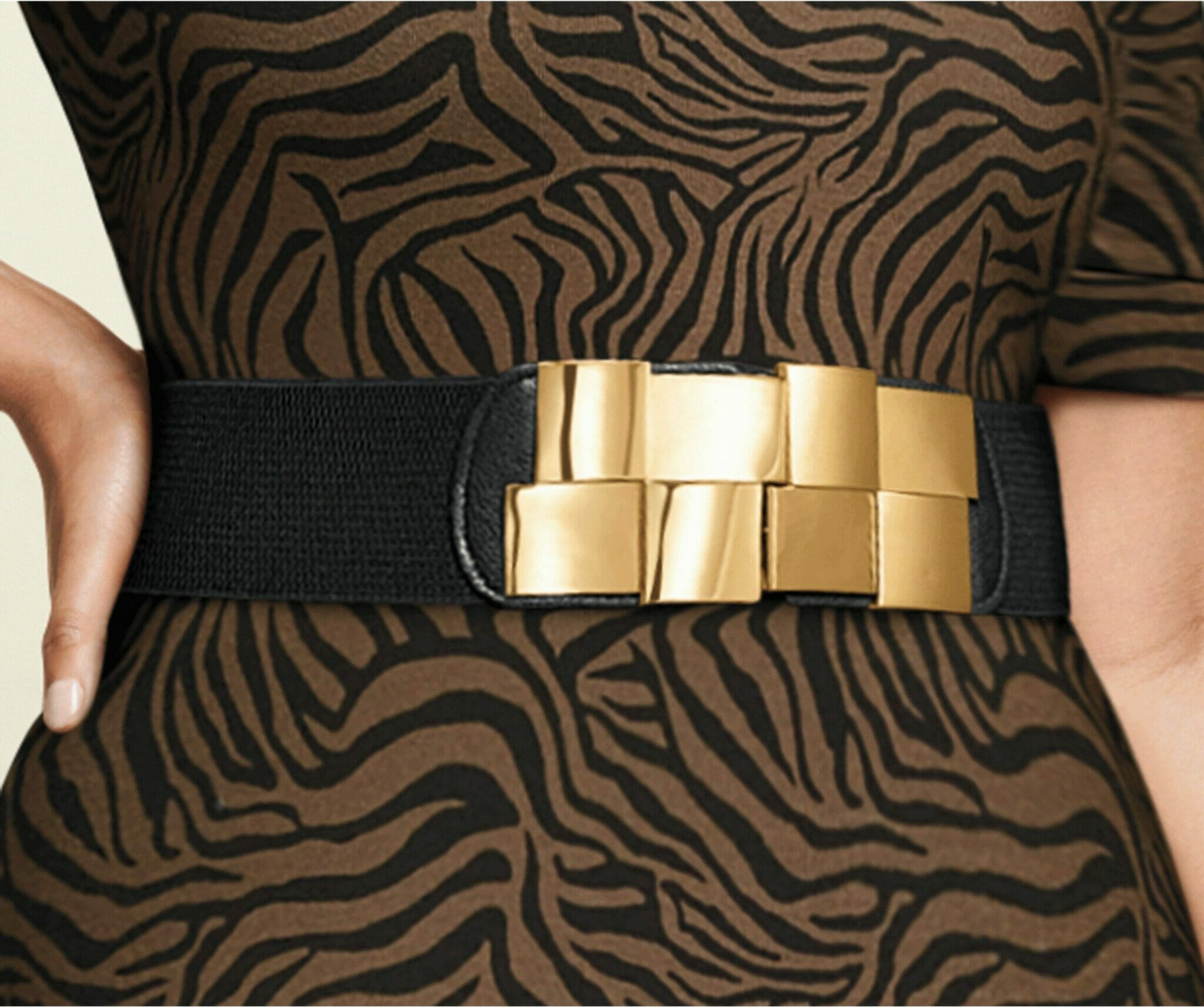 Model wearing brown zebra dress with black belt with gold buckle.