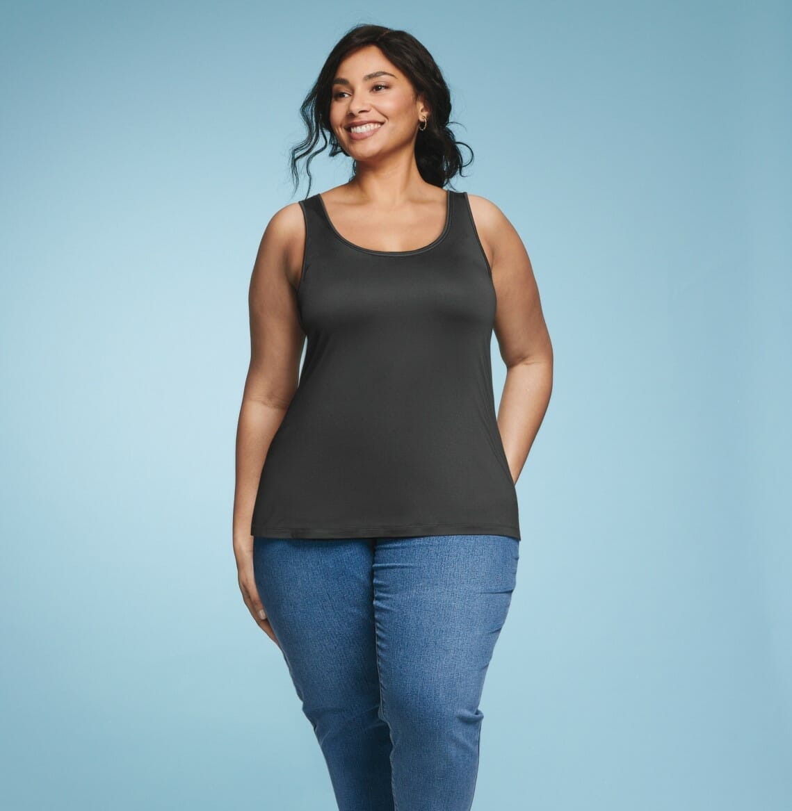 Plus Size Model wearing a black tank top with jeans.