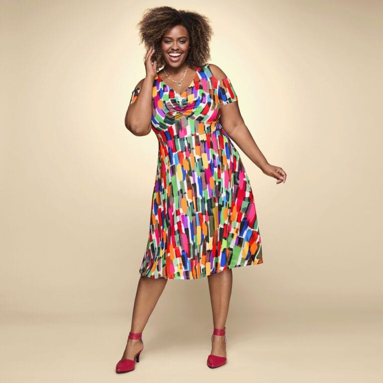 Plus size black woman in bright patterned dress