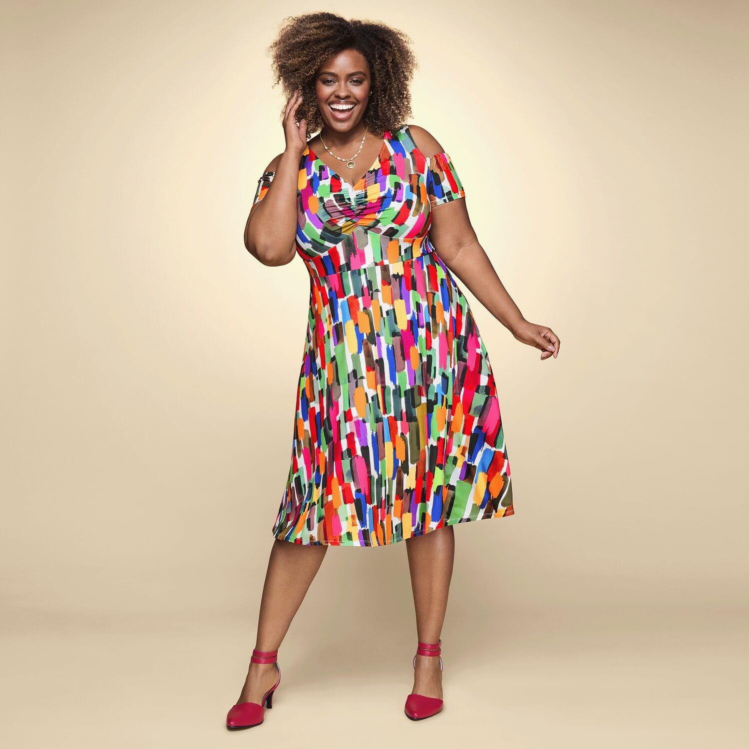 Plus size black woman in bright patterned dress