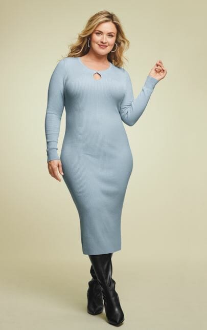 plus size blonde model wearing a baby blue dress and black leather boots