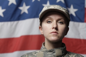 Female American Soldier in front of Flag