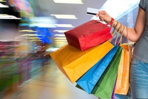 Woman carrying several colored shopping bags