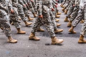 Military in boots and camo, marching
